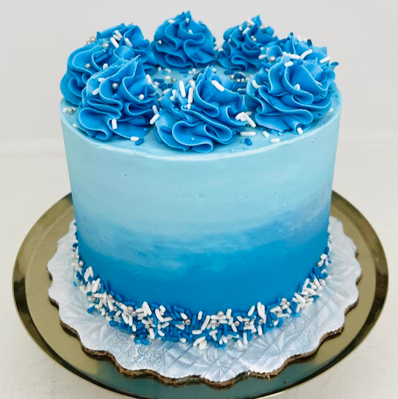 Blue cake with decorative rosettes on a white background