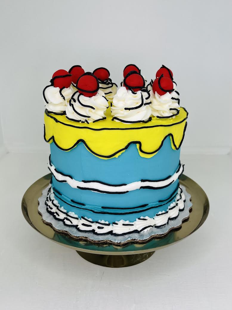 Two-layer cake with yellow and blue frosting, white whipped cream, and red berries on a white background.