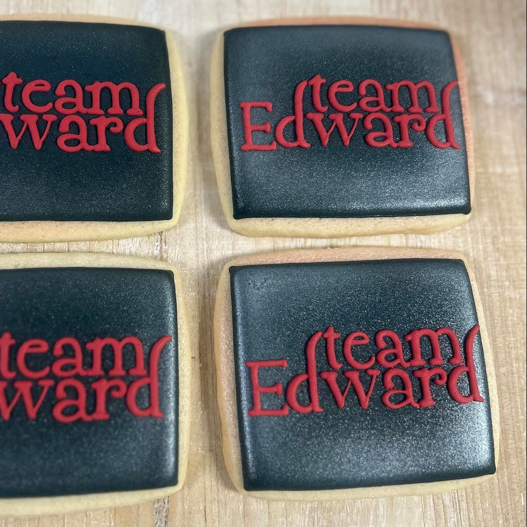 Four cookies with 'team Edward' text in red on a light background
