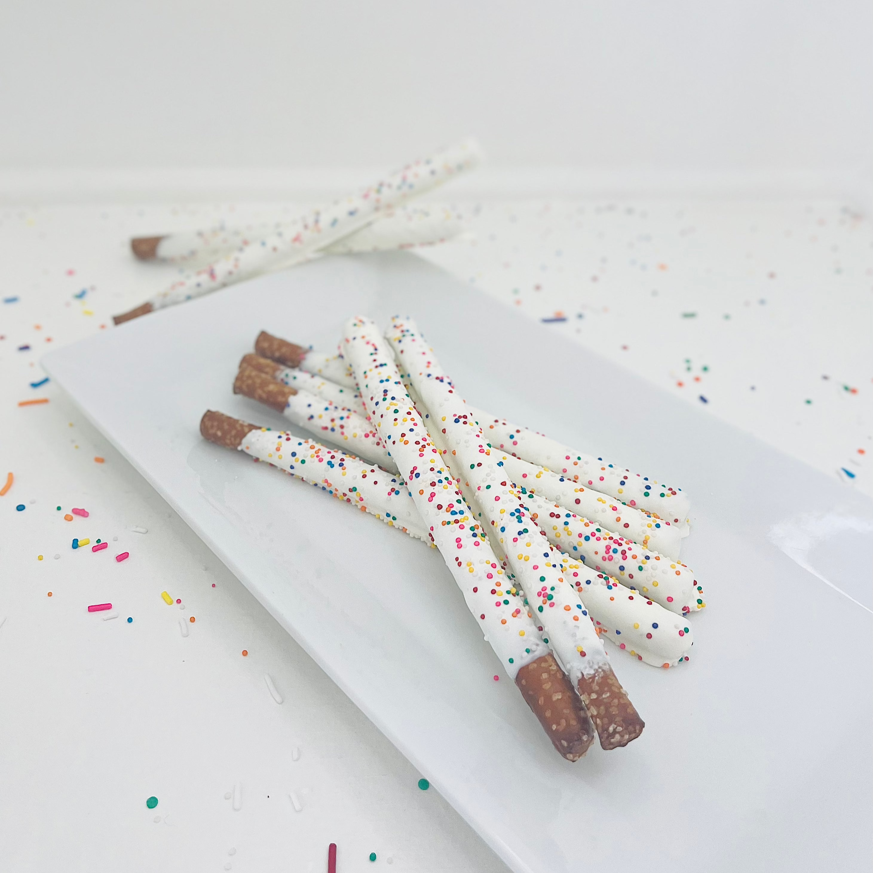 White Chocolate Dipped Pretzel Rods with Sprinkles