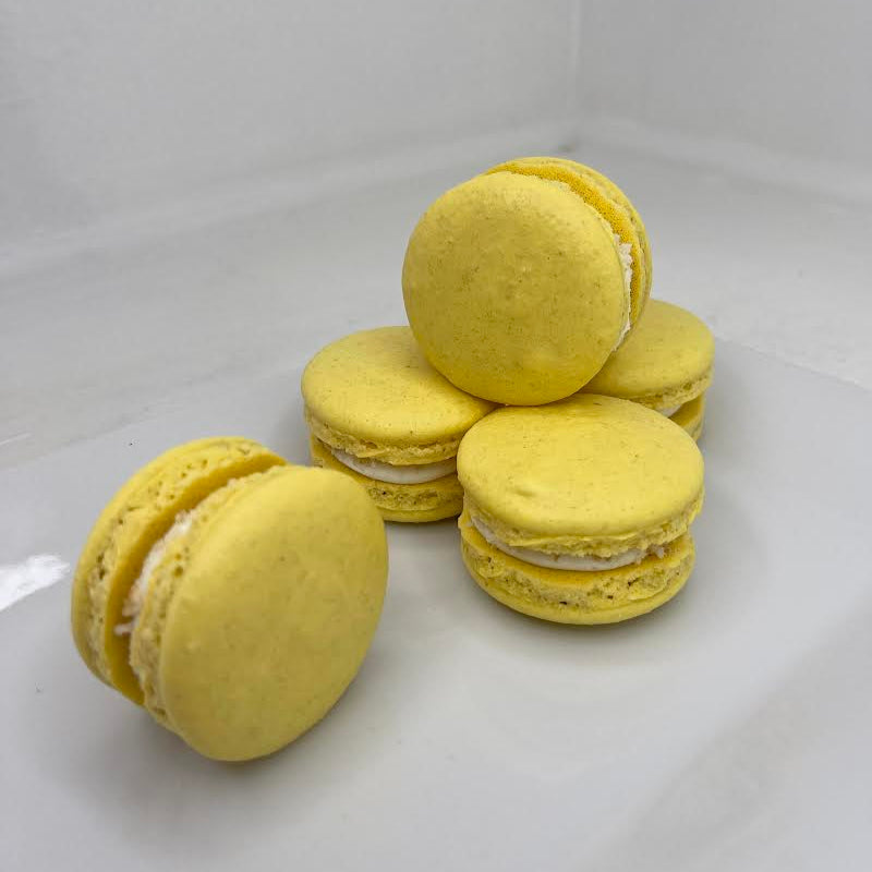 Yellow macarons on a white background